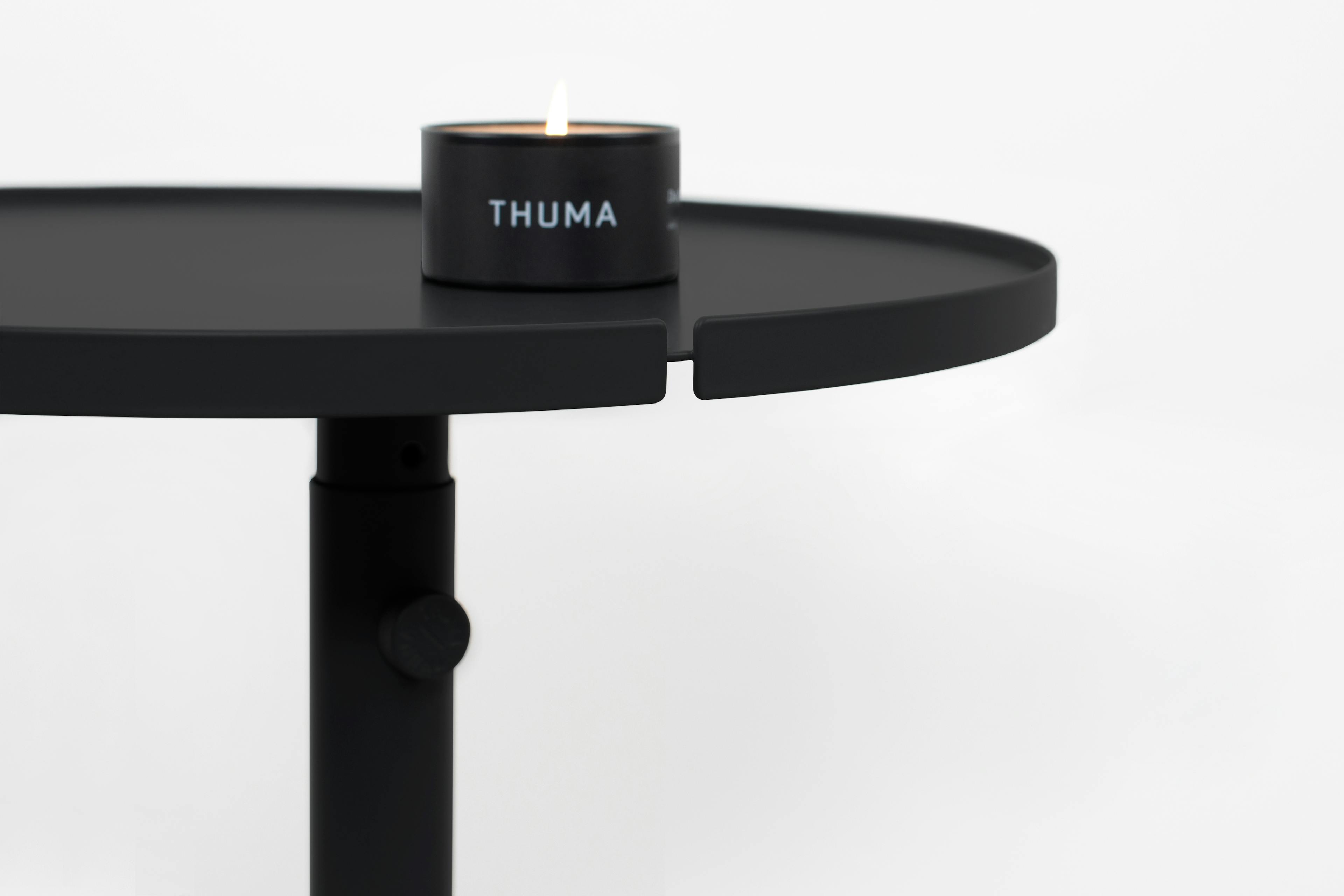 The Side Table in Matte Black Displayed in a Modern Living Room Setting