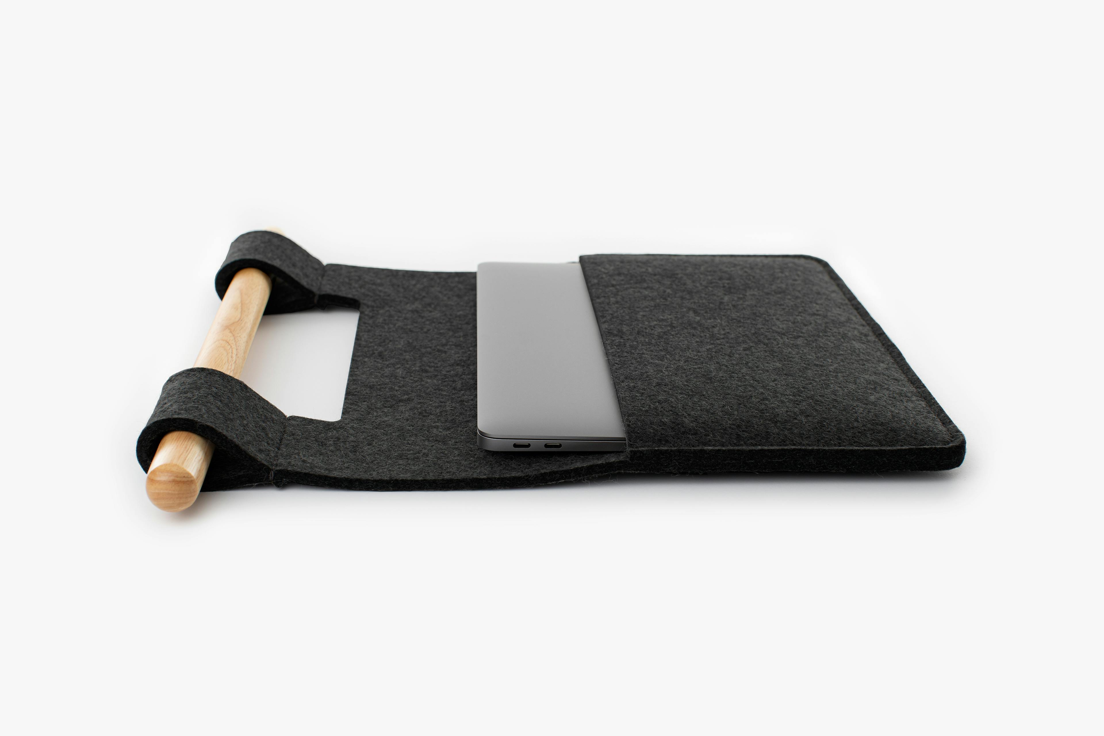 The Sleeve Product in Midnight Color with Laptop on Top