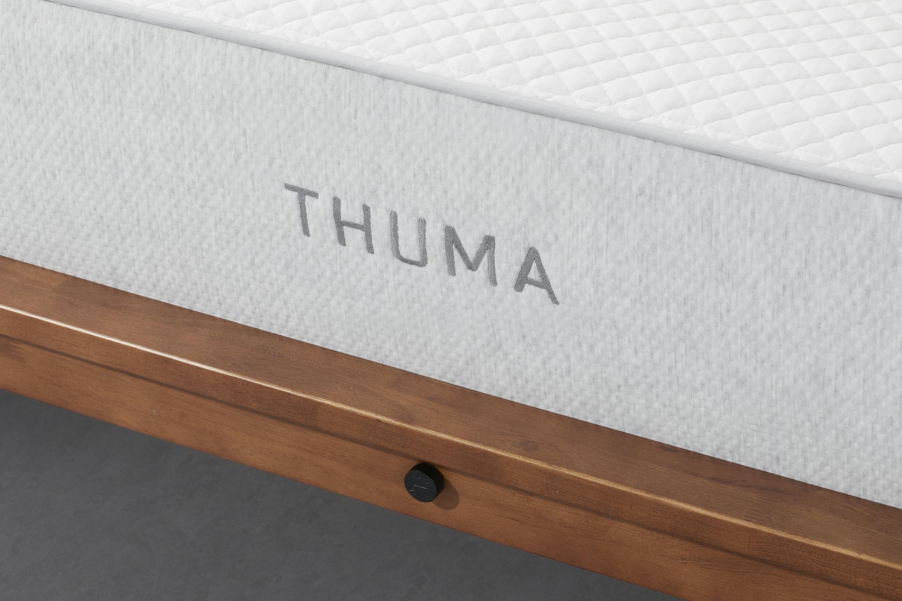 The Mattress Displayed on a Wooden Bed Frame