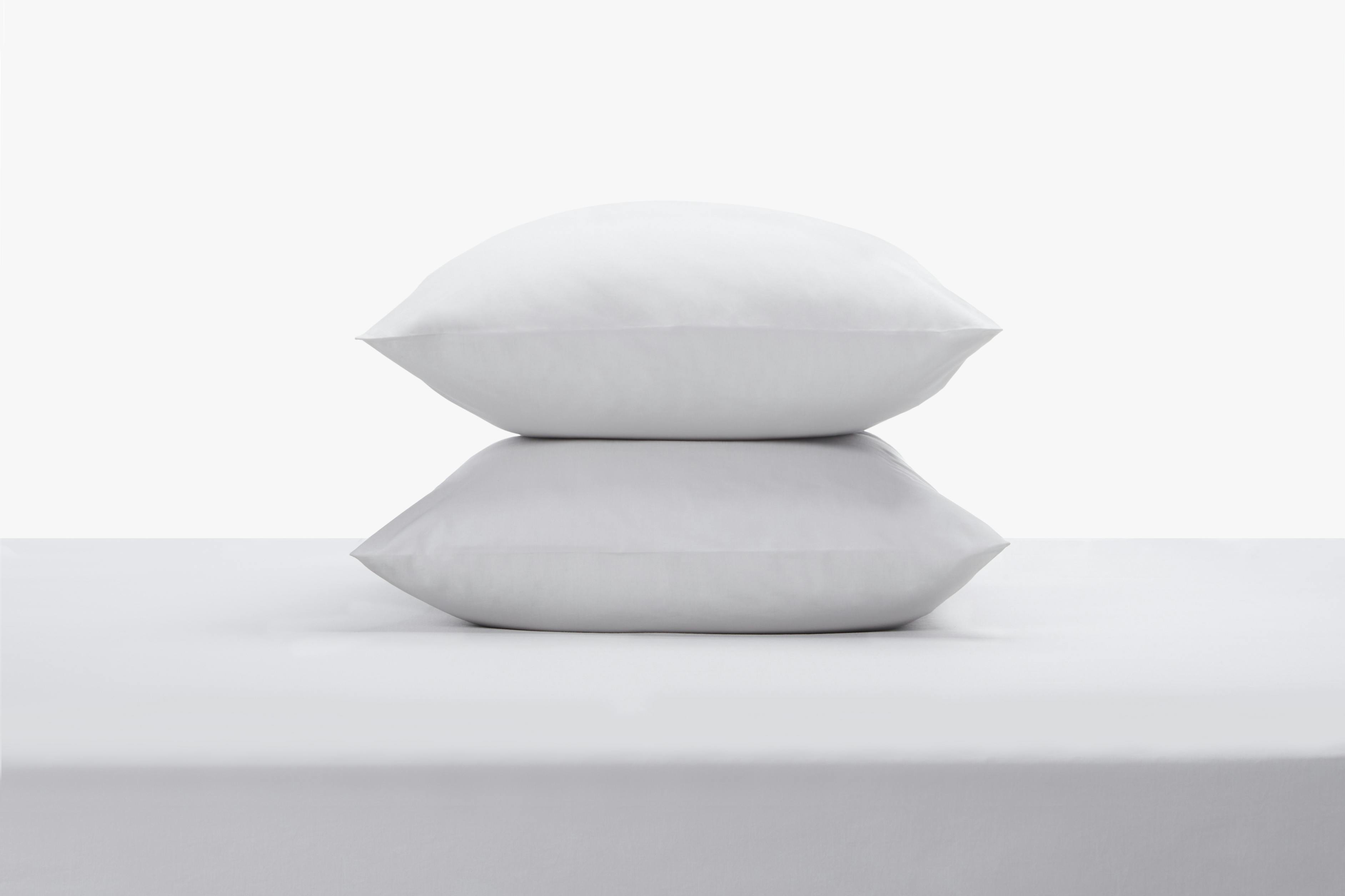 The Bed with Percale Sheet Set in Stone Color and Stacked Pillows